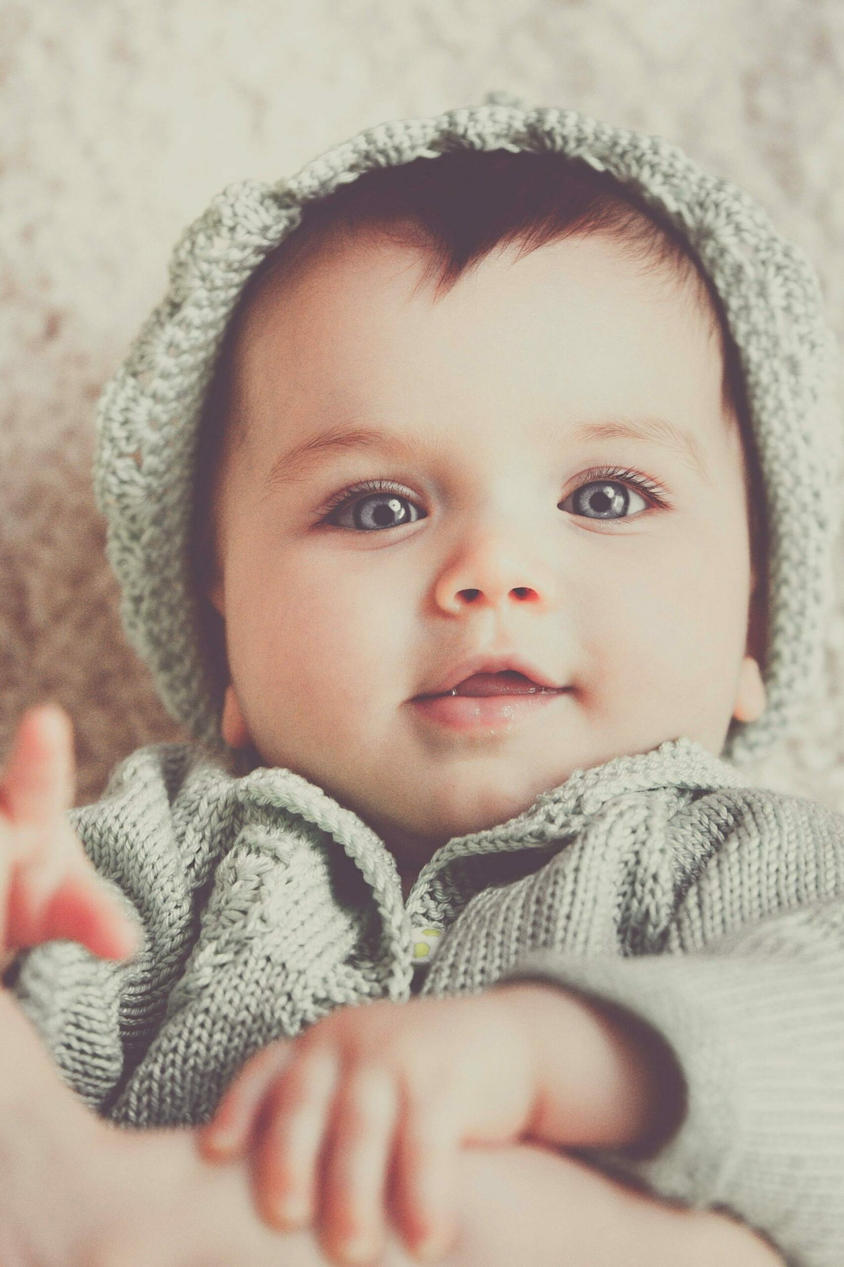 Ecrire les premiers mois de vie de son enfant Un bébé sourit en regardant l'objectif. Cela illustre le fait qu'on puisse raconter les premiers mois de vie de son enfant dans un livre biographique relatant un chapitre de vie.